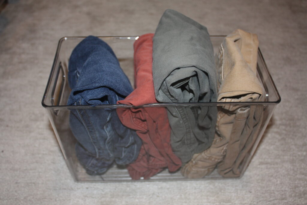 Kids' pants in a bin. Laundry hacks for families.