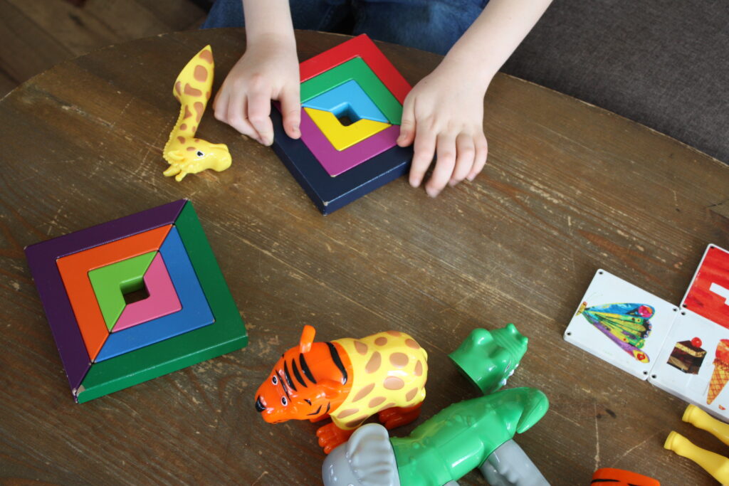 decluttering toys, geometric blocks, boy playing with blocks, magnetic toys