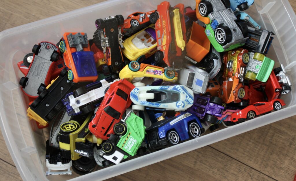 decluttering toys, hot wheels in storage bin, toy collection