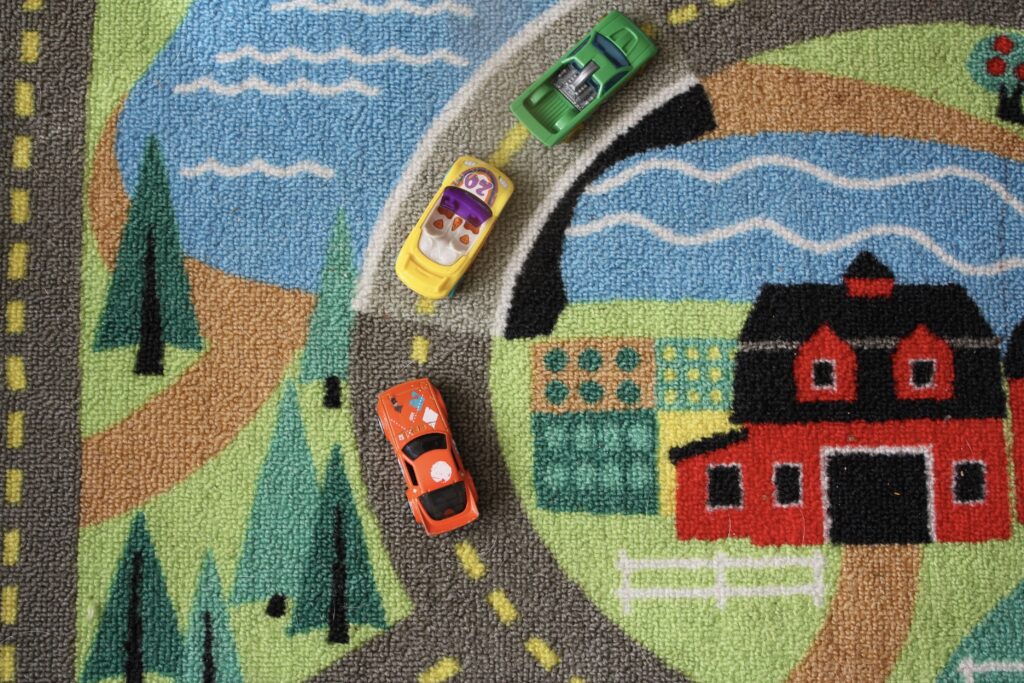 decluttering toys, hot wheel cars, road rug