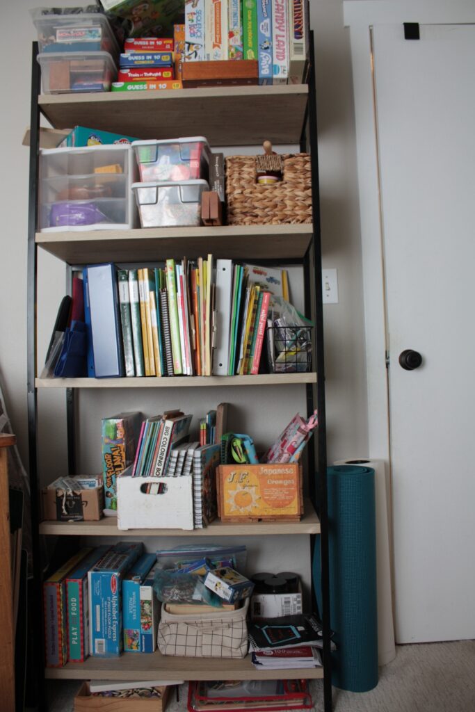 bookshelf with homeschool supplies